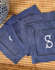 set of navy blue cocktail napkins embroidered with an initial