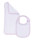 Baby bib and burp cloth set with pink trim on a white background
