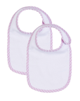 Two white baby bibs with pink gingham trim on a white background