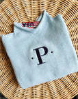 light blue cotton rollneck sweater for kids folded with personalized embroidery
