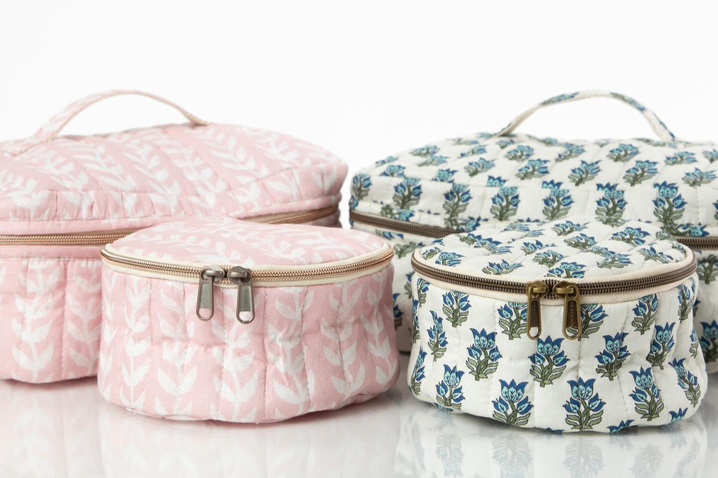 Set of block print patterned cosmetic bags on a white background