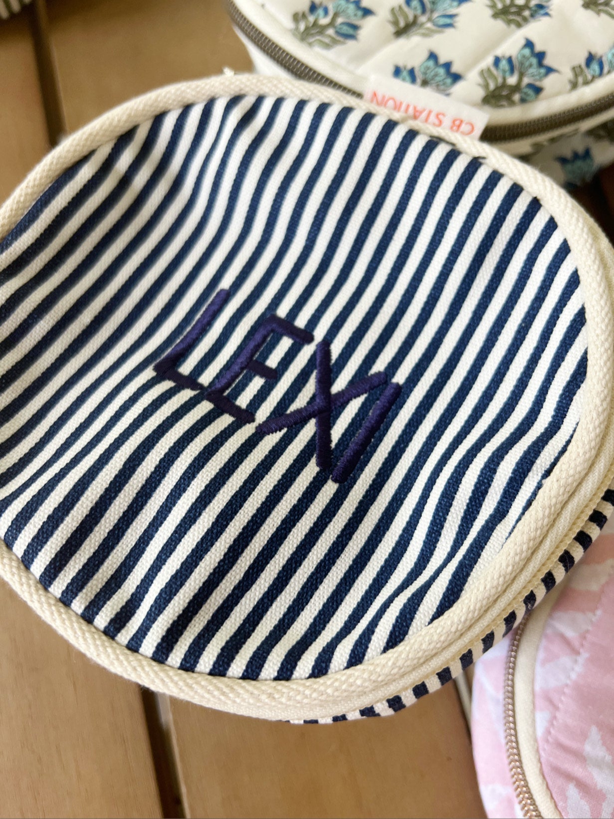 navy pinstripe round travel case with embroidered name