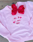 Light pink girls sweatshirt with multicolor ‘Jesus Loves Me’ embroidery in pink and red thread