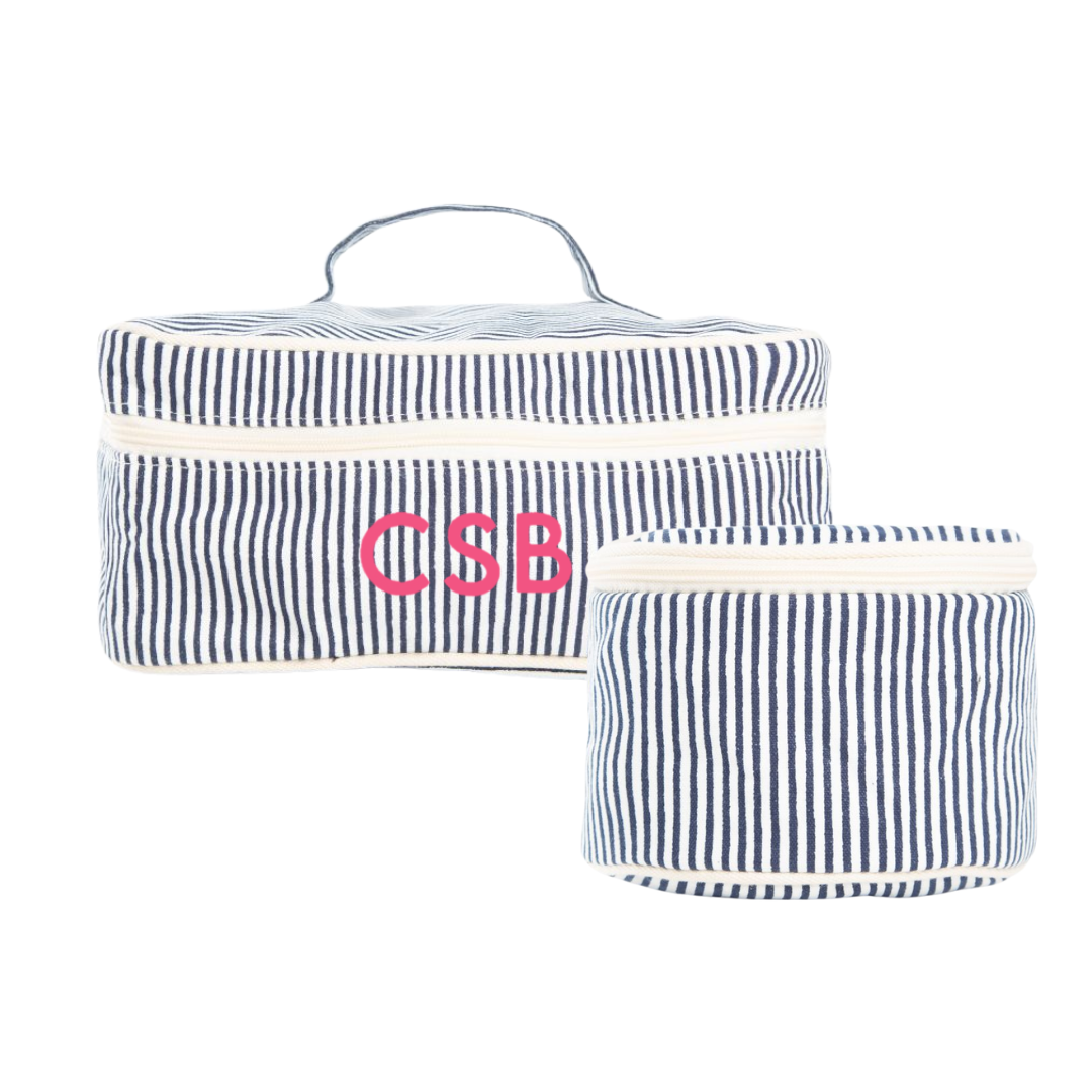 Two navy and white striped travel bags with custom embroidered initials on a white background