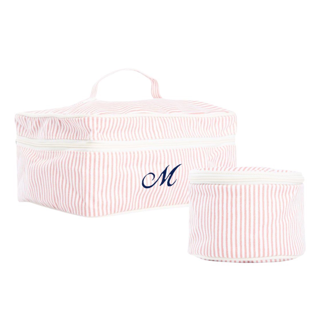 Two pink striped travel organizers with a monogram on a white background