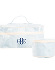 Set of two blue and white striped travel bags with embroidered monogram on a white background