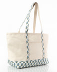 large canvas tote bag with block print patterned handle and bottom edge on a white background