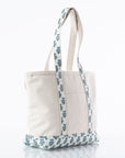 canvas tote bag with block print trim handles and front pocket on white background