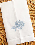 white linen guest towel with embroidered blue hydrangea motif