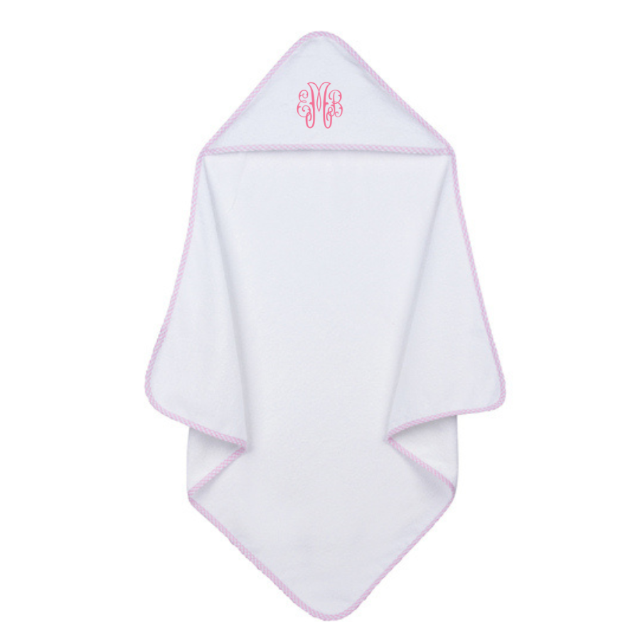 White hooded baby towel with pink trim and monogram on a white background