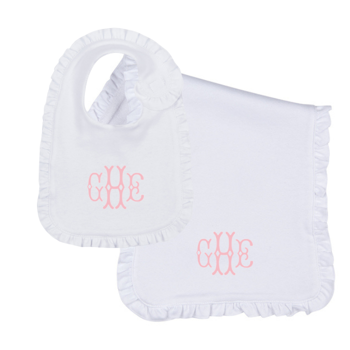 white ruffle bip and burp cloth set with pink embroidered monogram on white background
