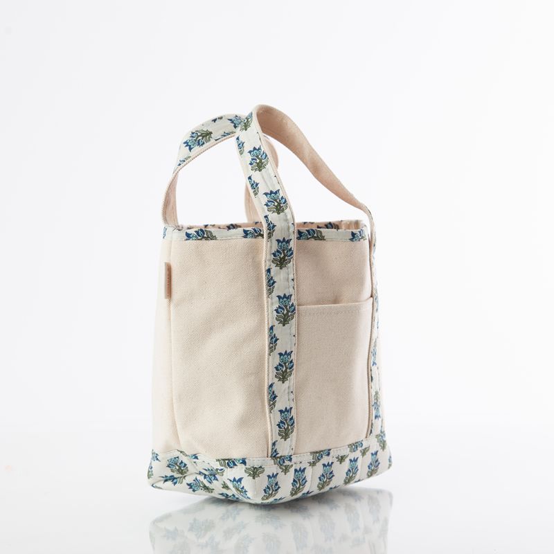 small open top canvas tote bag with blue and green block print trim on handles and bottom on white background