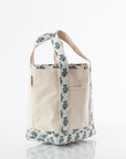 small open top canvas tote bag with blue and green block print trim on handles and bottom on white background