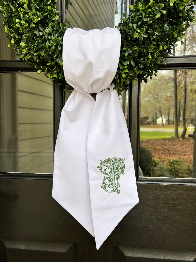 white linen wreath sash with personalized embroidered initial